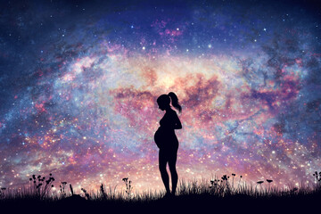 Pregnant woman expecting on night sky with nebula and stars.