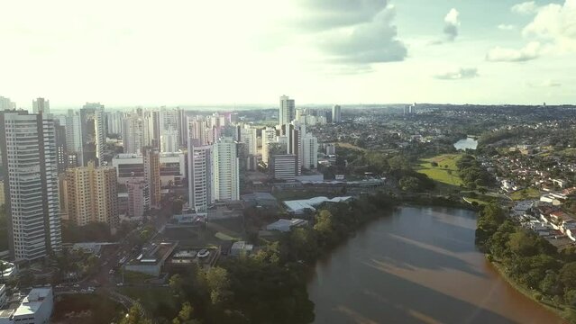 A lake in the middle of a big city surrounded by buildings