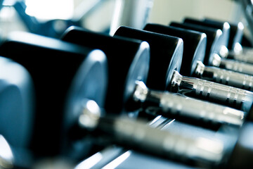 Rows of dumbbells in the gym
