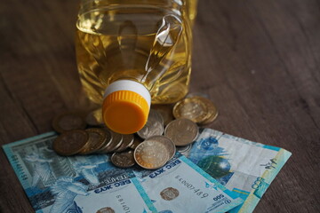 Sunflower oil in a plastic bottle and Kazakhstani money - tenge.