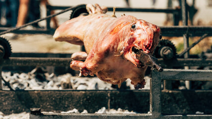 Spit roasting lamb on traditional outdoor festival