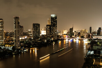 Fototapeta na wymiar Night cityscape along the Chao Phraya River in Bangkok, Thailand.