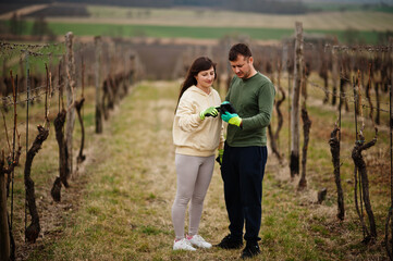 Couple working on vineyard in early spring.