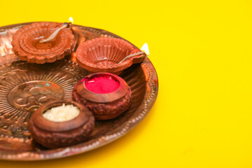 Indian festival diwali concept. Traditional puja thali on yellow background.