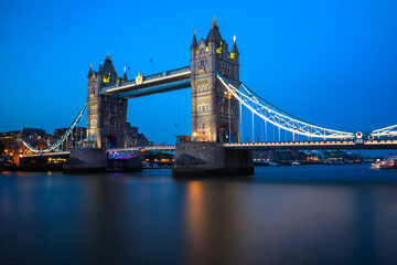 Illuminated Tower Bridge over river Thames in London at night