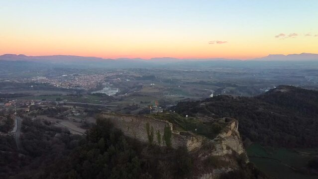 Aerial view historic and medieval castle ruins on a cliff at sunset