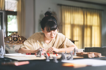 Fototapeta premium Young adult asian woman enjoying role playing tabletop and board game