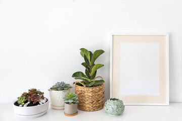 Fototapeta premium Minimalism Nordic closet shelves neatly folded bed linens and potted plants frame border copy space
