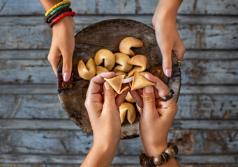 Fortune cookies at the hands of two women.
