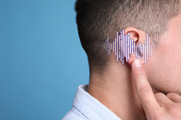Hearing loss concept. Man and sound waves illustration on light blue background, closeup with space for text