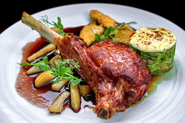 Meat on the bone with sauce and vegetables