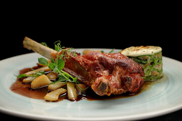Meat on the bone with sauce and vegetables