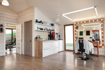 Fototapeta premium Stylish barbershop interior with professional hairdresser's workplace
