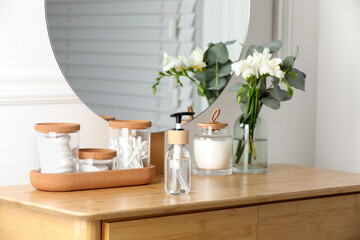 Bottle with dispenser cap on wooden table indoors
