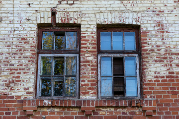 Old windows in the facade of a red brick building