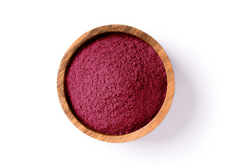 Dried beet root purple powder in wooden bowl isolated on white background. Top view. Flat lay.