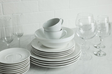 Different clean dishware, cups and glasses on countertop