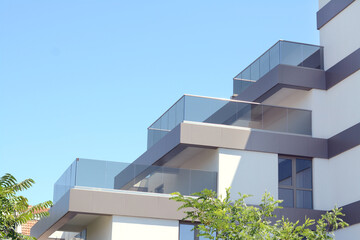 Exterior of beautiful residential building against blue sky