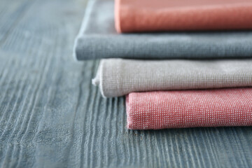 Different colorful napkins on wooden table, closeup. Space for text