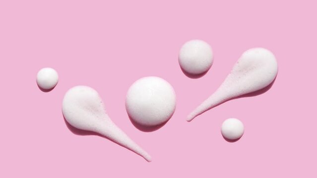 texture foam mousse foam cosmetic smear sample on pink background