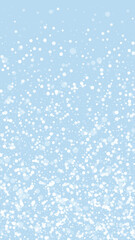 Snowy christmas background. Subtle flying snow flakes and stars on light blue winter backdrop. Delicate sweet snowy christmas. Vertical vector illustration.