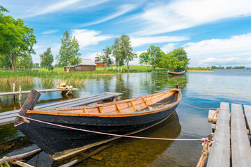 old wooden boat in a small picturesque bay on the lake