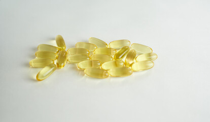 Fish oil omega 3 capsules on a white background in the shape of a fish. Healthy Heart.