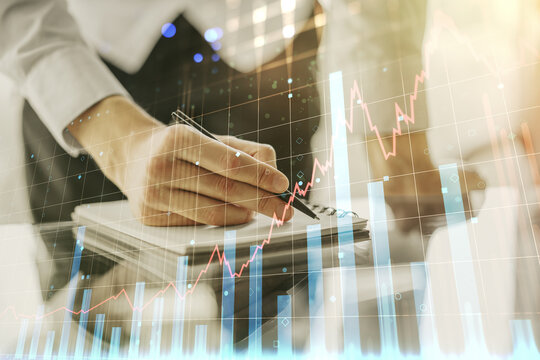 Abstract creative financial graph with hand writing in diary on background, financial and trading concept. Multiexposure