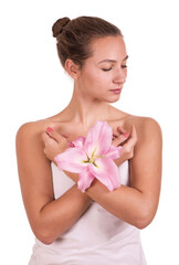 Beauty face of the young beautiful woman with flower. Female touching skin.