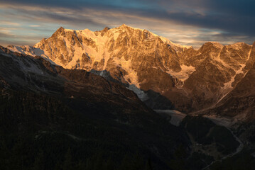 Obraz premium Mountain with glacier at sunrise. Monte Rosa in the European alps, Macugnaga, Italy. Spectacular rock and ice wall