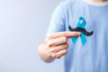 November Prostate Cancer Awareness month, Blue Ribbon with mustache for supporting people living...