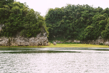 Beautiful nature scenic landscape with mountain range clear view on blue sky and wooden raft floating in Khao Laem National Park in the morning at Vajiralongkorn Dam, Kanchanaburi, Thailand.