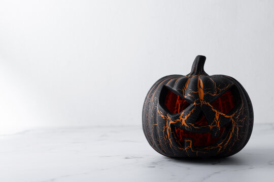 Black Halloween pumpkin on white background. Copy space