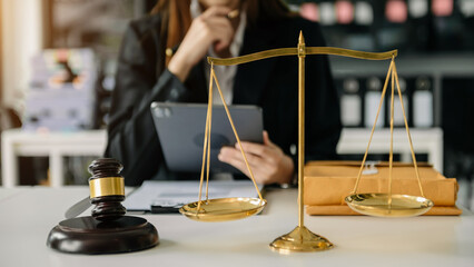Male lawyer in the office with brass scale on wooden table. justice and law concept in morning light
