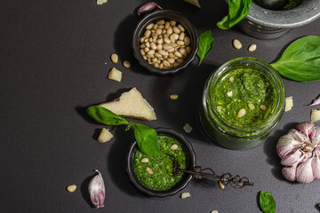 Homemade Italian basil pesto sauce in a vintage mortar with pestle