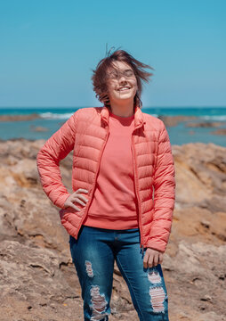 Happy Teenager Girl Wearing Pink Shirt And Pudded Jucket Outdoor Near The Sea, Mockup