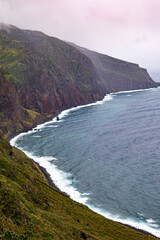Fototapeta na wymiar Farol da Ponta do Pargo coastline on rainy day 
