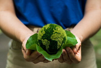 Love world and earth day concept. Young woman holding the earth in hand for ecology care and environment sustainable.