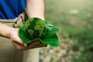 Love world and earth day concept. Young woman holding the earth in hand for ecology care and environment sustainable.