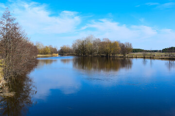 The river on the background of the blue sky in the afternoon in autumn
