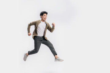 Full length Asian man running jumping in air gesture with happy smile on isolated white background....