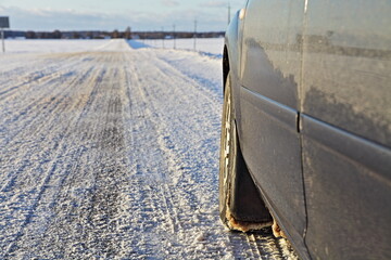 Car winter tyre on snowy road