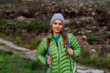 Portrait of smiling female caucasian hiker in winter clothes