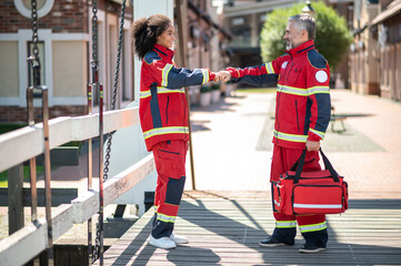 Paramedical staff greeting one another on the street