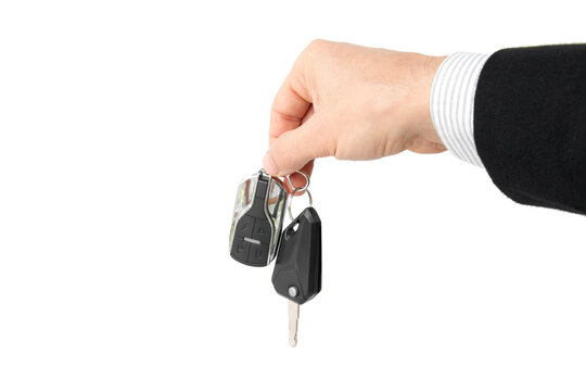 Businessman holding car key, isolated