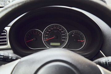 car dashboard and steering wheel. speedometer