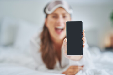 Brunette sexy girl on bed with phone