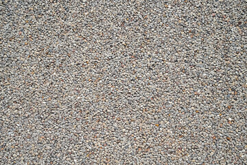 Pattern of gravel on road, grey stone pebbles background