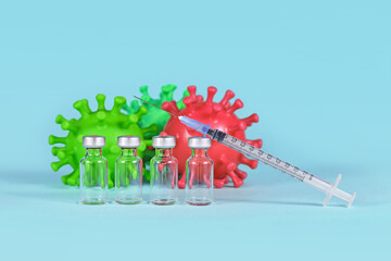 Corona booster vaccine concept with 4 vials with syringe and virus models in background