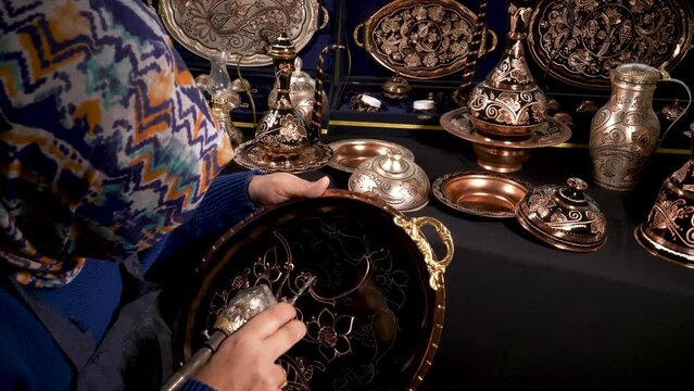 Handicrafts. Traditional motifs embroidered on copper with various tools, copper ornament art. Engraving eye-catching patterns on copper.